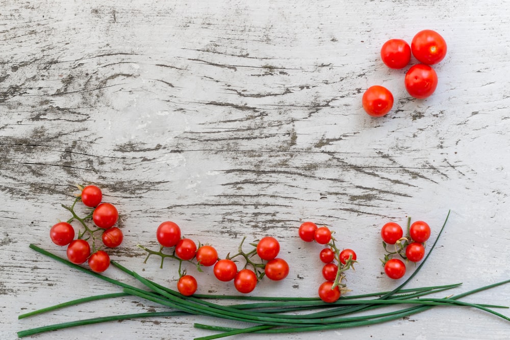 red citrus berries on gray surface