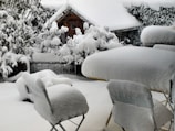 A winter scene of a veranda with snow-covered surroundings.