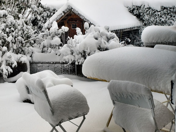A winter scene of a veranda with snow-covered surroundings.