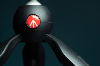 An elegant tripod set against a dark background, highlighting its sturdy build and smooth joints.