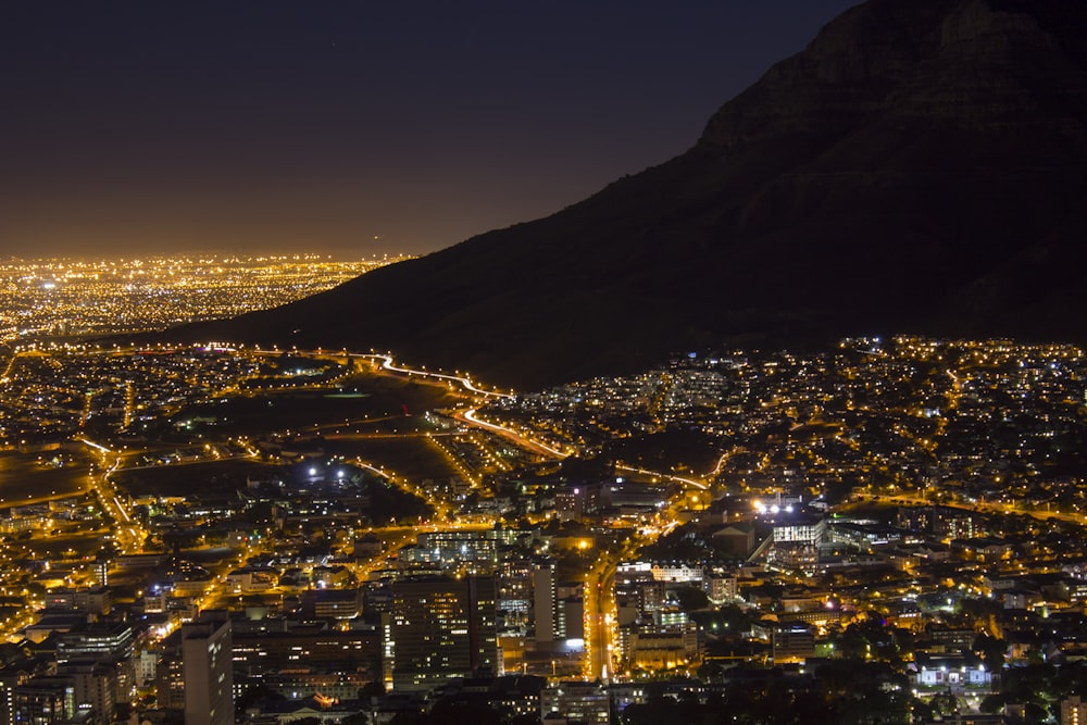 a view of a city at night from the top of a mountain