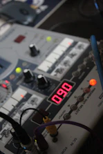 Close-up of a technician testing TV speakers with specialized equipment.