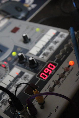 Close-up of a digital-to-analog converter device with glowing indicators, highlighting precision audio technology.