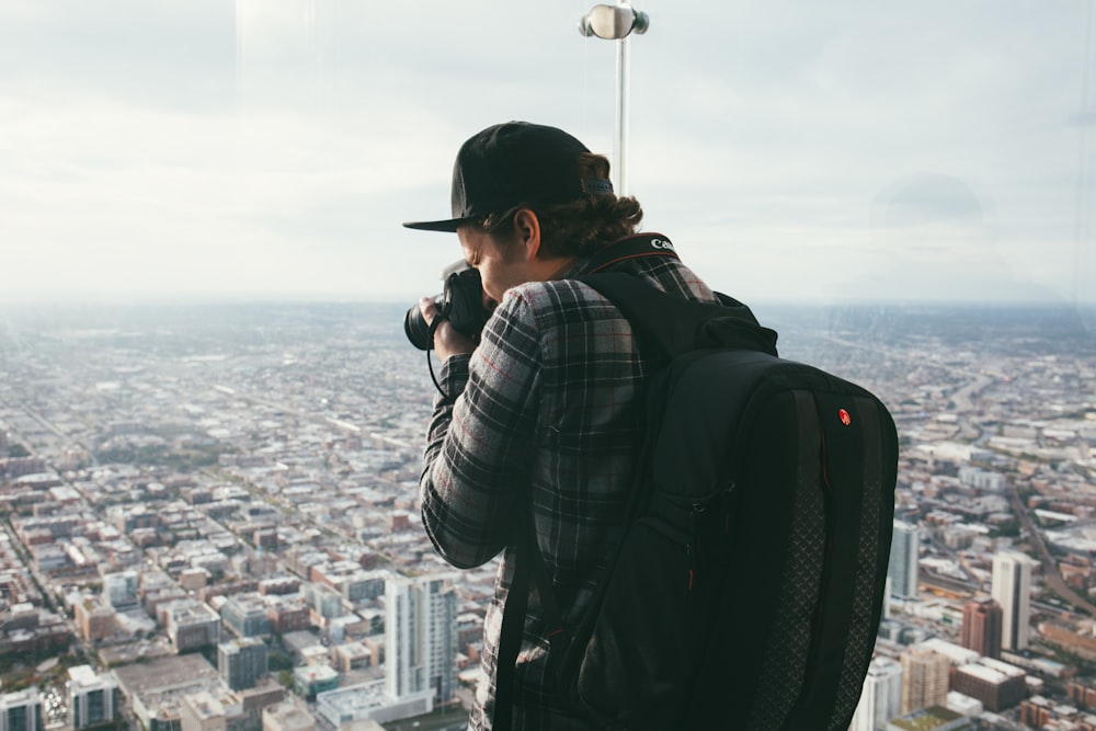 man taking photo of buildings