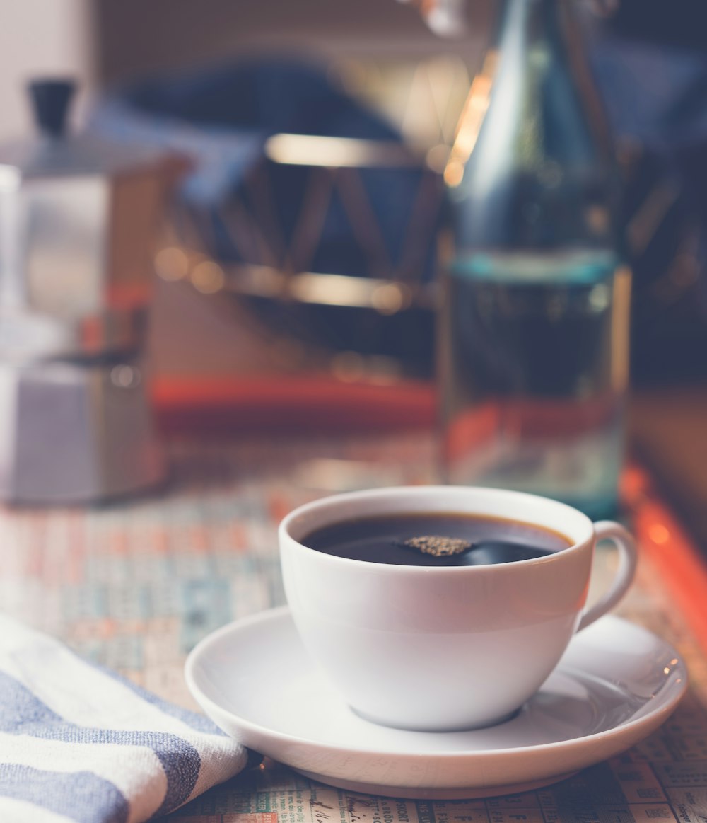 white ceramic cup on white ceramic saucer