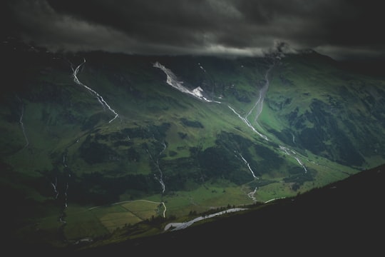 green mountain under dark cloudy sky in Grossglocker Austria