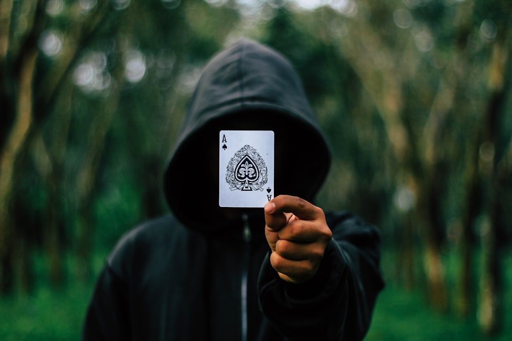 man holding Ace of Spade card