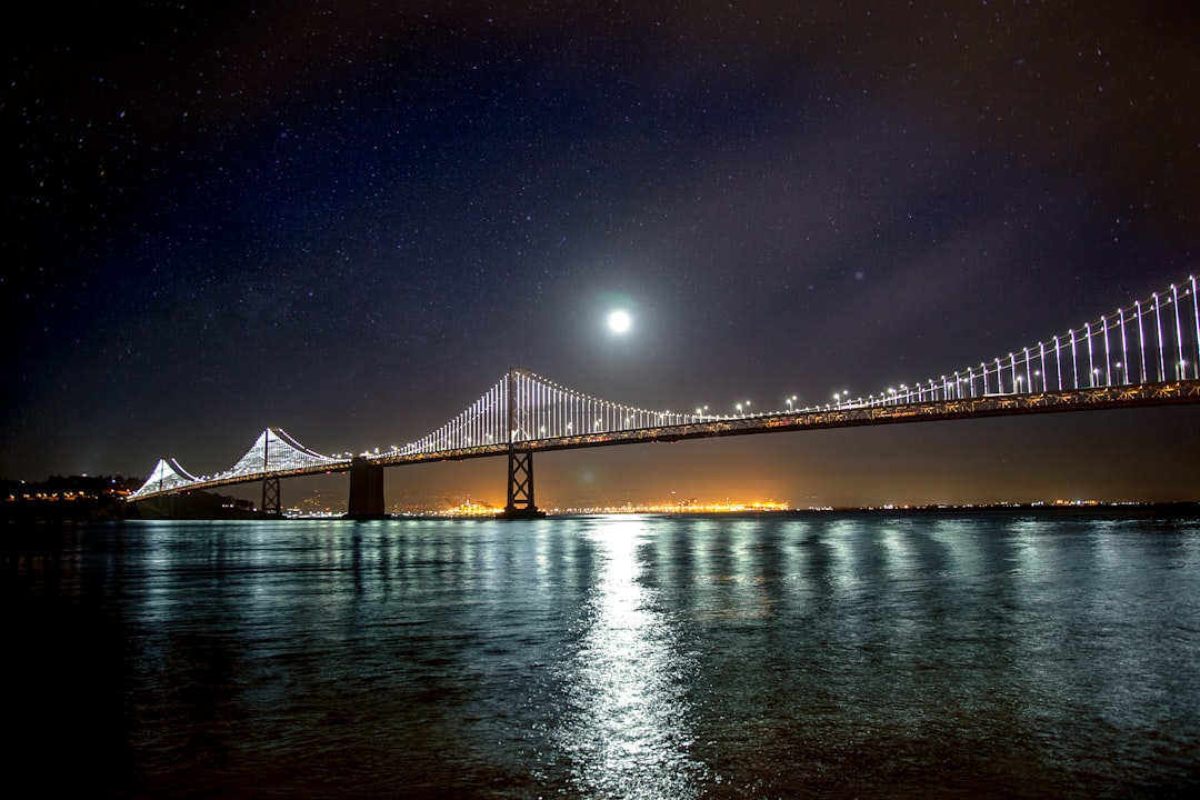 Moon over the San Francisco – Oakland Bay suspension Bridge reflected on the water below
