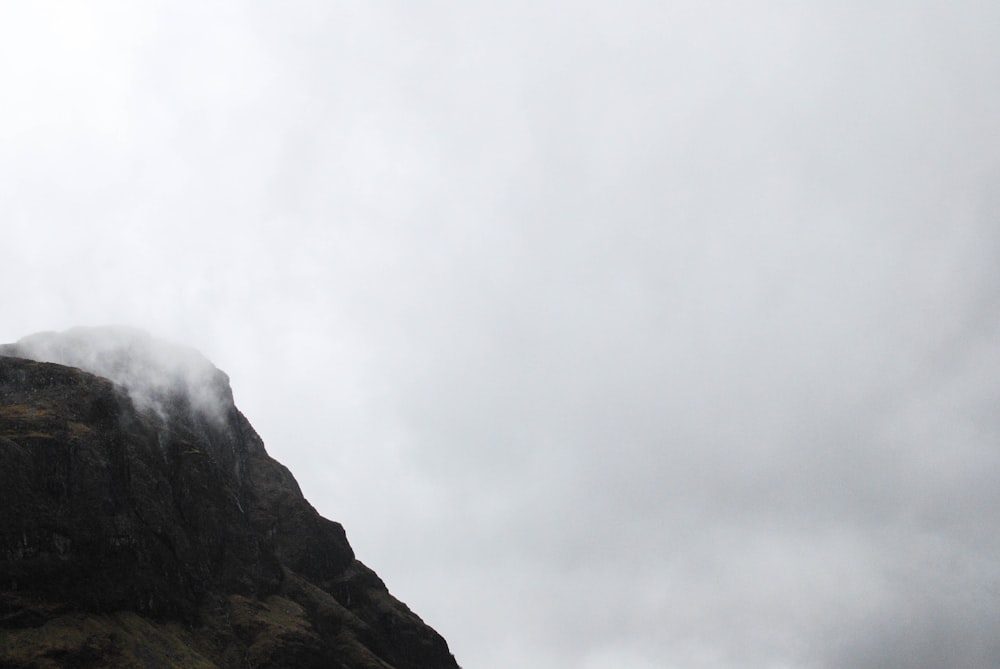 rocky mountain surrounded by fog