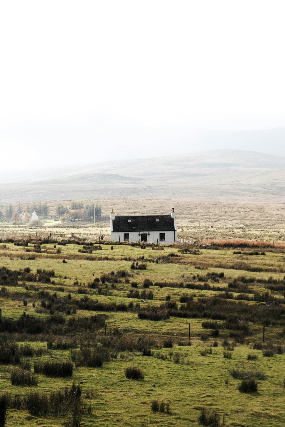 whit and black house in the middle of wide open landscape