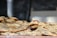 Close-up of golden, fluffy naan bread stacked on a rustic wooden board.