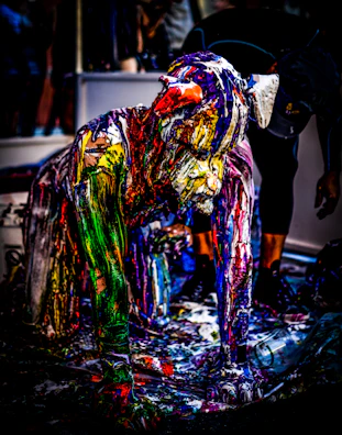 Spray artist mid-action, surrounded by a mist of red and yellow paint with small skulls drifting behind.