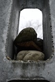 A sturdy rock dumpster filled with concrete debris.