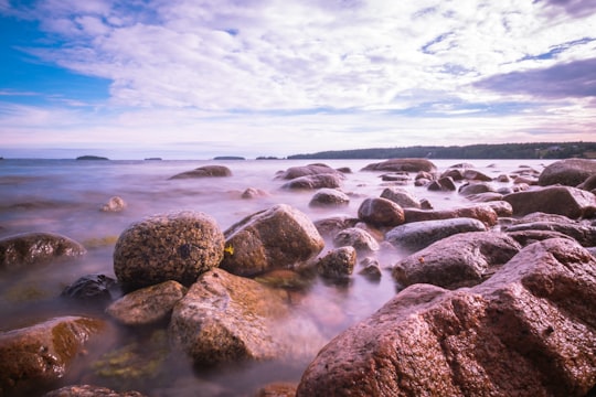 brown rocks beside beach in Lunenburg Canada