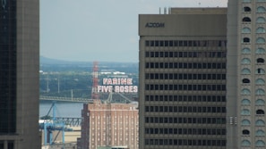An outdoor video shoot in Montreal featuring a local business owner, with the city skyline softly blurred in the background.
