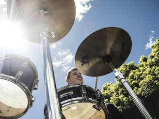 Close-up of a musician playing a steel drum under the Caribbean sun.