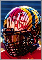 A detailed and vibrant close-up of a football helmet with intricate designs and reflective details, featuring bold, vivid colors and a shiny visor.