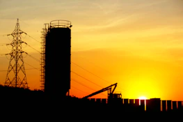 Aerial shot of energy infrastructure with subtle gold highlights at sunrise.