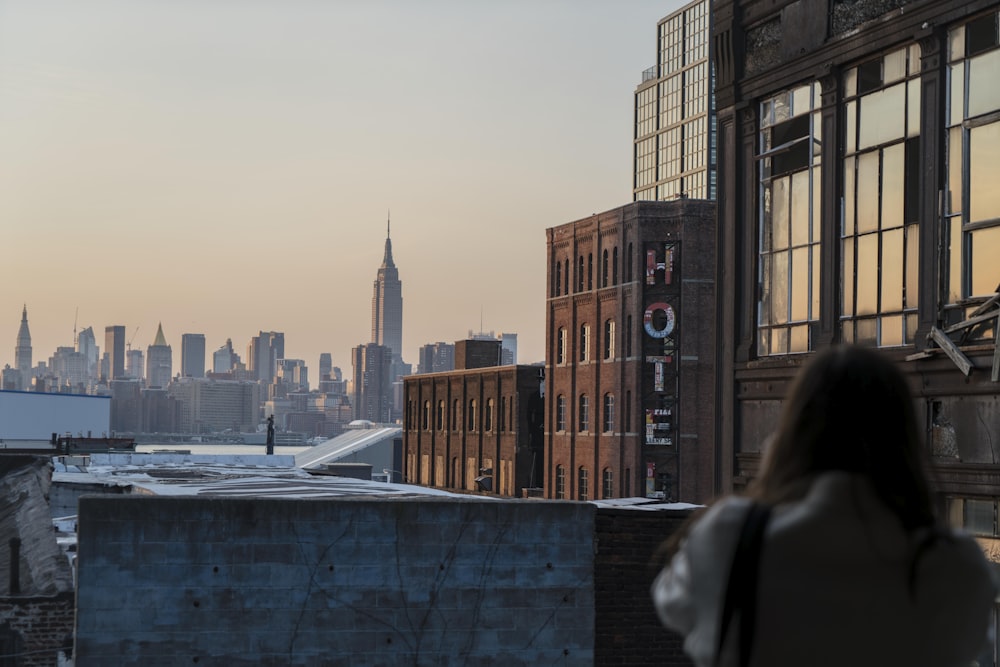 woman taking photo of buildings