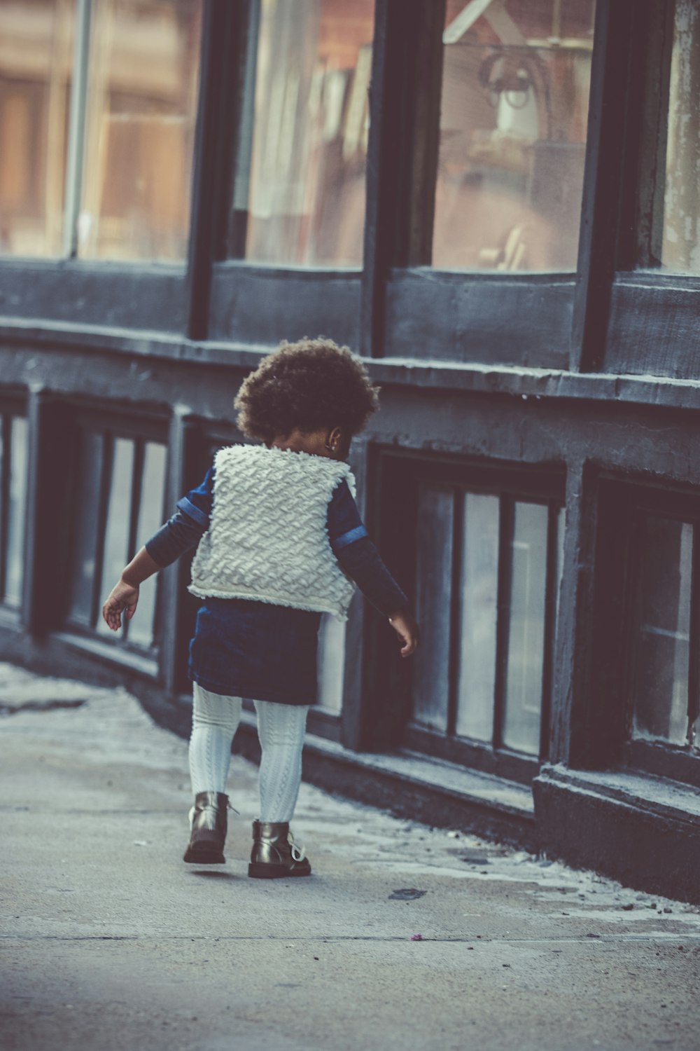 A kid walking down the street.