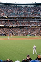 photo of baseball players in stadium during daytime
