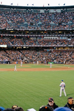 Baseball players in uniform on the field at a stadium during a daytime game