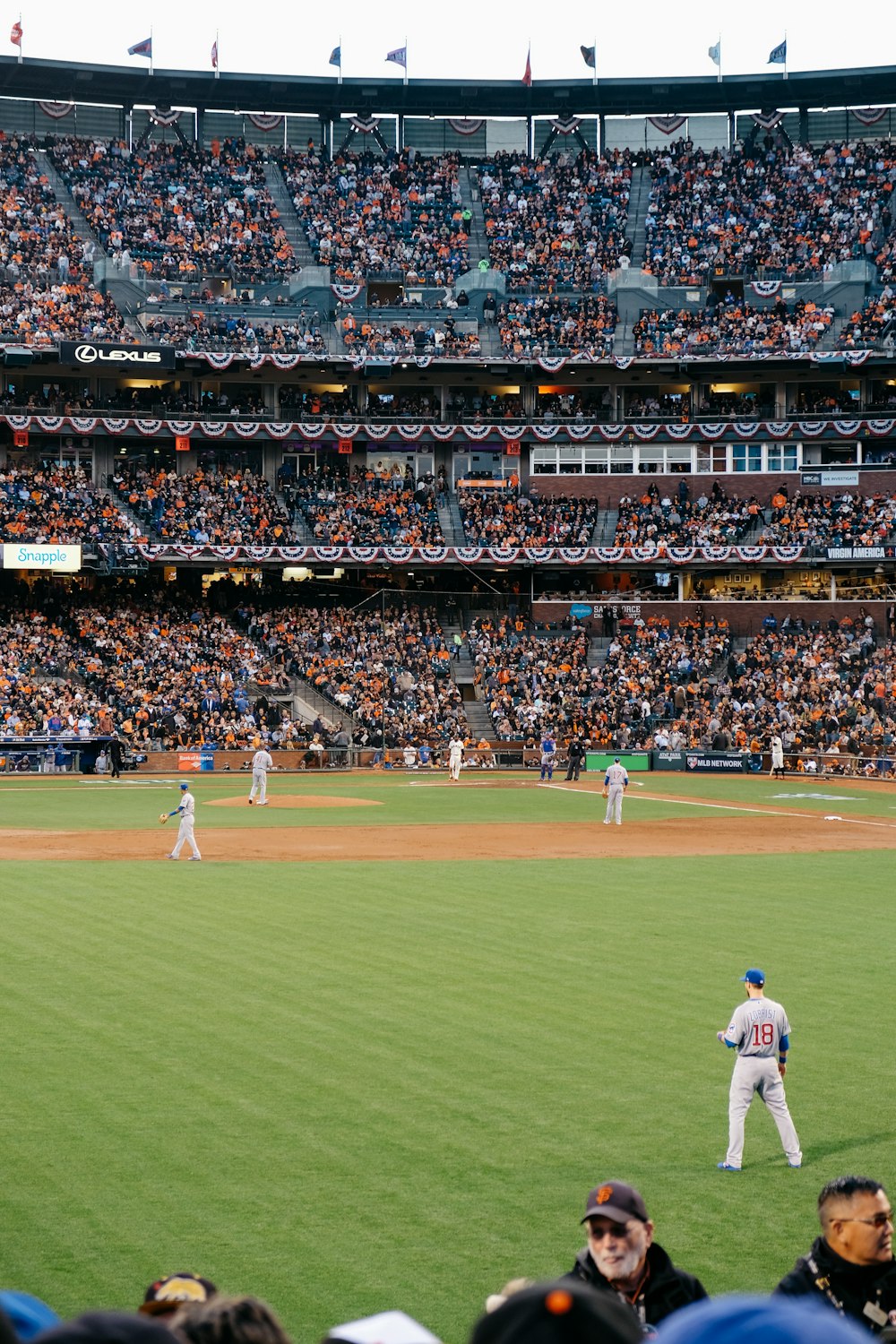 photo of baseball players in stadium during daytime