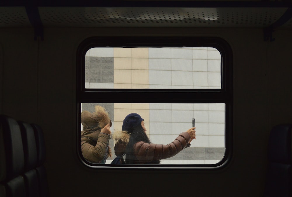 woman taking photo outside train