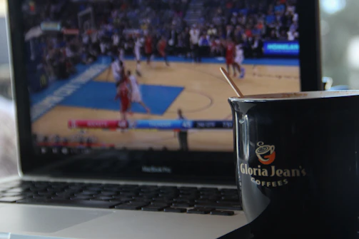 Close-up of a scout analyzing game footage on a laptop.