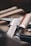 Close-up of hands holding construction tools on a wooden workbench.