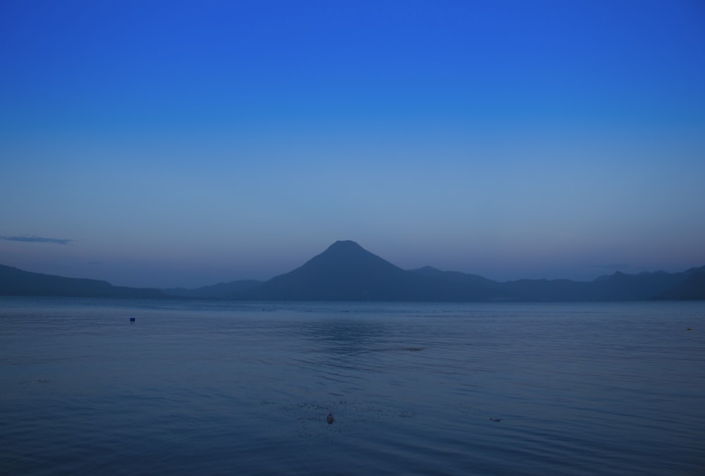 silhouette of mountains between sea and sky