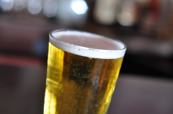 A vibrant photo of a craft beer glass filled with golden lager.