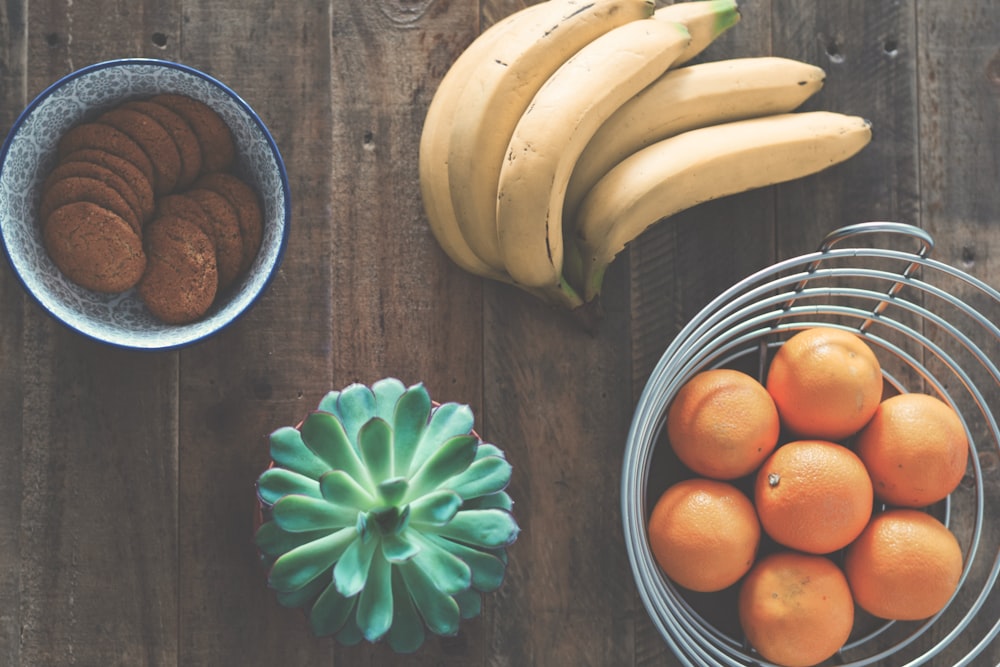 ripe banana fruit beside stainless steel fruit rack