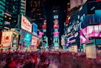 time-lapse photography of crowd of people on New York Time square during night time