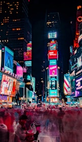 time-lapse photography of crowd of people on New York Time square during night time