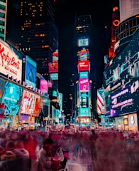 time-lapse photography of crowd of people on New York Time square during night time