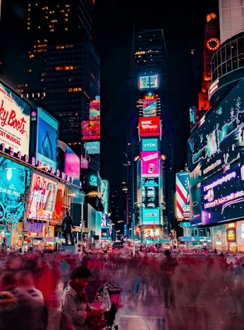 time-lapse photography of crowd of people on New York Time square during night time