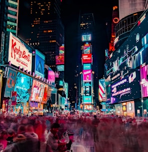 time-lapse photography of crowd of people on New York Time square during night time