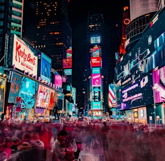 time-lapse photography of crowd of people on New York Time square during night time