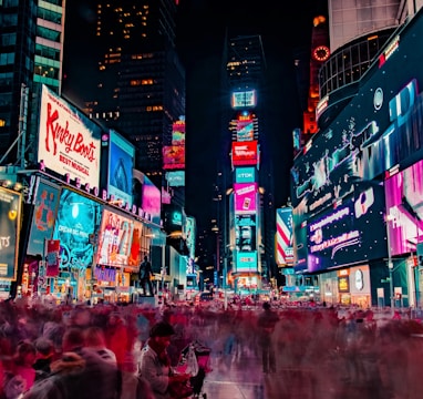 time-lapse photography of crowd of people on New York Time square during night time