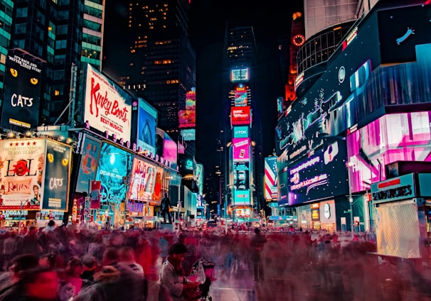 time-lapse photography of crowd of people on New York Time square during night time