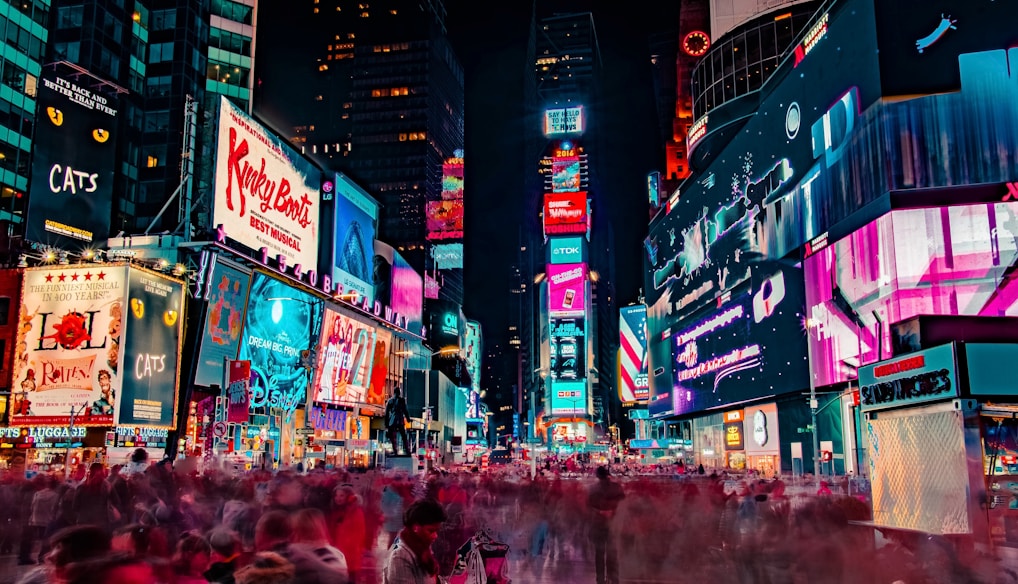 time-lapse photography of crowd of people on New York Time square during night time