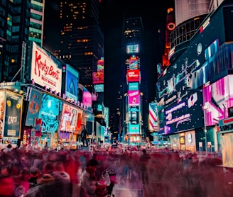 time-lapse photography of crowd of people on New York Time square during night time