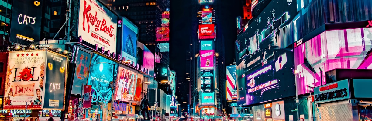 time-lapse photography of crowd of people on New York Time square during night time