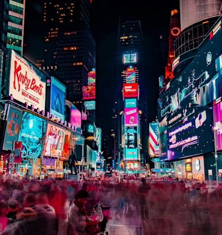 time-lapse photography of crowd of people on New York Time square during night time