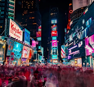 time-lapse photography of crowd of people on New York Time square during night time