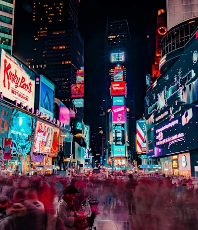 time-lapse photography of crowd of people on New York Time square during night time