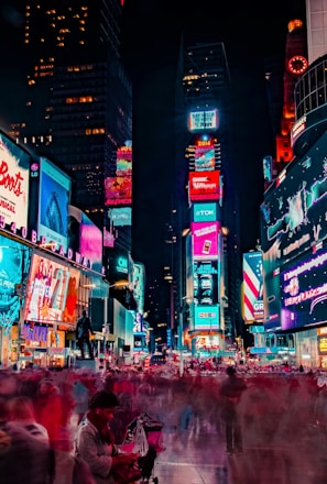 time-lapse photography of crowd of people on New York Time square during night time