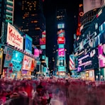 time-lapse photography of crowd of people on New York Time square during night time