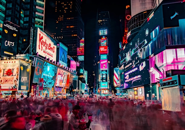 time-lapse photography of crowd of people on New York Time square during night time